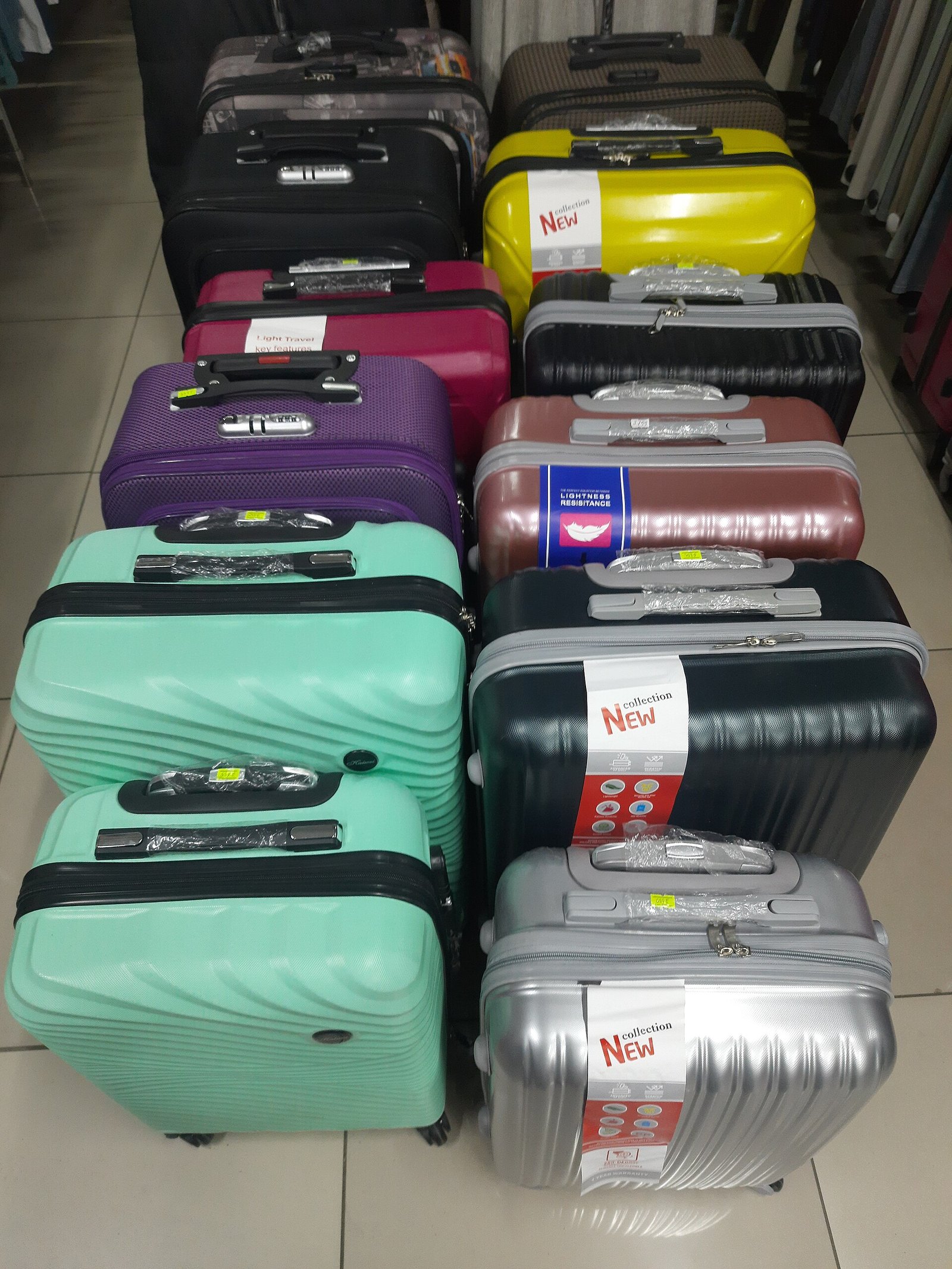 Stacked suitcases displayed in a bright retail setting